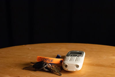 Close-up of telephone on table against black background