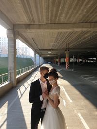 Woman with umbrella on bridge