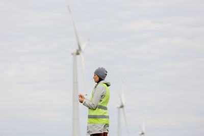 Low angle view of man standing against sky