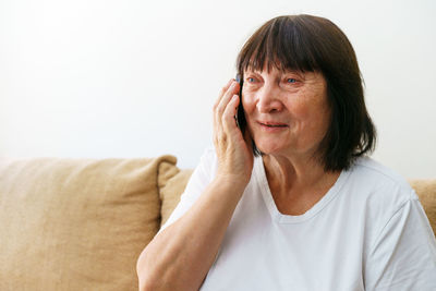 Cellular. portrait of cheerful caucasian grandmother calling with family while