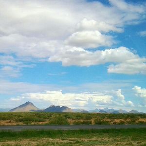 Scenic view of mountains against cloudy sky