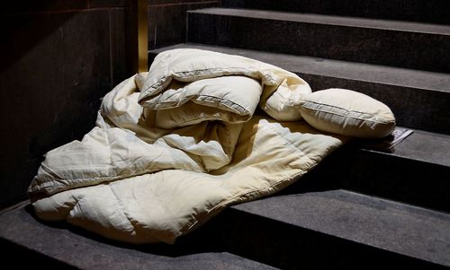 High angle view of mattress and pillow on steps at home