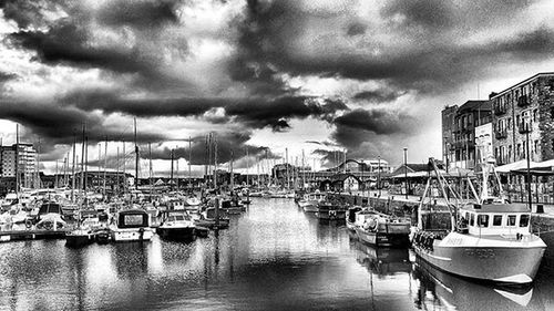 Boats in river with city in background