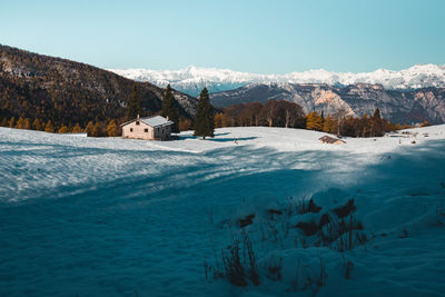 Scenic view of snow covered mountains against sky