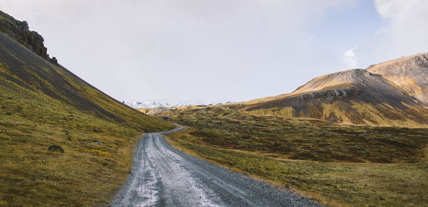 Road amidst landscape against sky