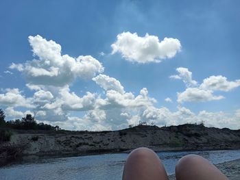 Low section of woman against sky