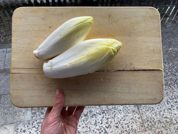 High angle view of fresh chicory vegetable on cutting board