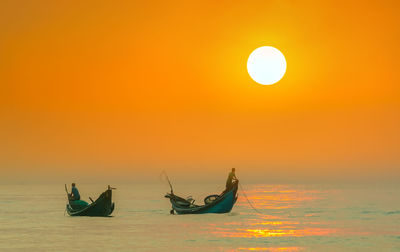 Scenic view of sea against orange sky