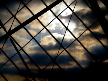 Low angle view of sky seen through chainlink fence