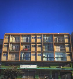 Low angle view of building against clear blue sky