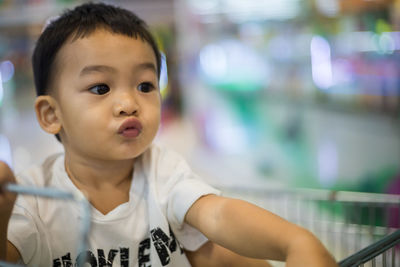 Close-up of cute boy puckering in store