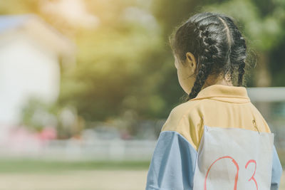 Rear view of girl wearing mask