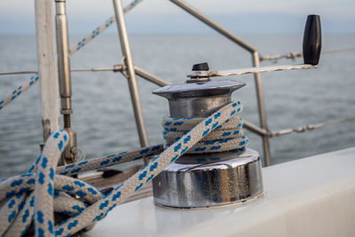 Close-up of rope tied to bollard on boat