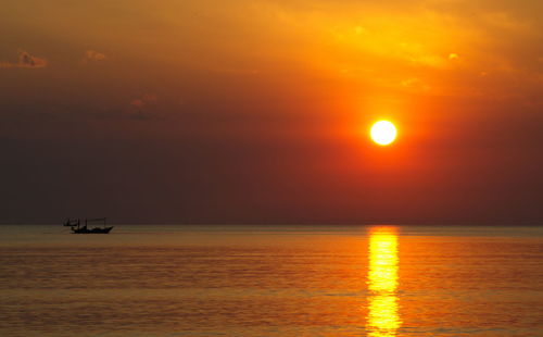 Scenic view of sea against orange sky