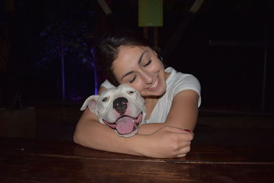 Portrait of woman with dog on floor