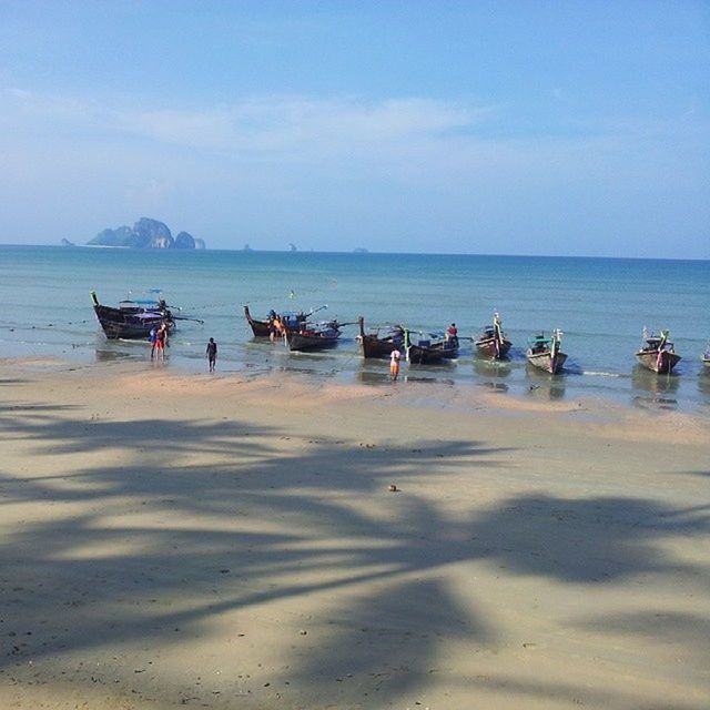 sea, water, beach, nautical vessel, sky, sand, horizon over water, shore, boat, tranquility, tranquil scene, transportation, scenics, moored, beauty in nature, mode of transport, nature, incidental people, idyllic, blue