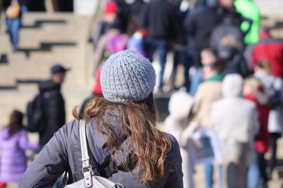 People walking on city street during sunny day