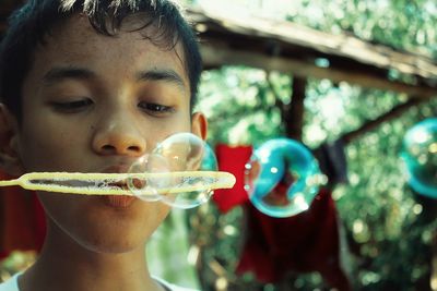 Close-up of boy drinking water