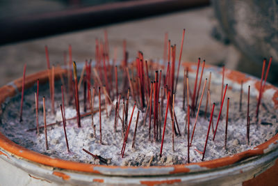 Burnt incense sticks in a pot.