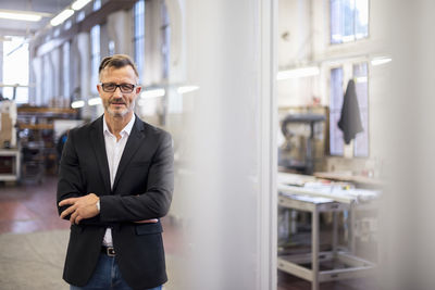 Portrait of smiling mature businessman in factory