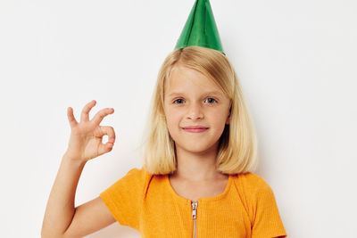 Portrait of young woman against white background