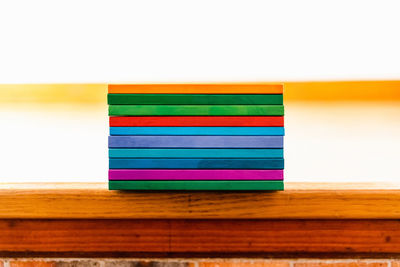 Close-up of multi colored pencils on table against white background