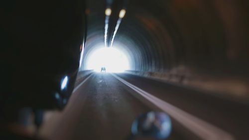 Illuminated tunnel at night