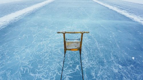 High angle view of pier over frozen lake during winter