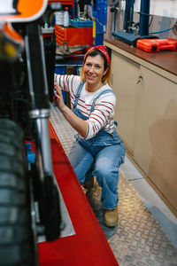 Portrait of young woman sitting in gym