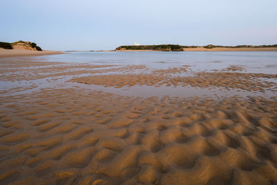 Scenic view of beach against clear sky