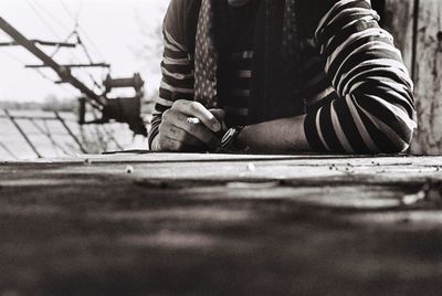 Close-up of man holding cigarette