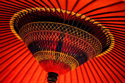 Pattern of the umbrella made of wood and rope, ancient colors, bright colors.
