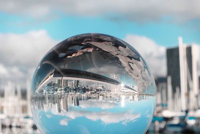 Digital composite image of people on glass against buildings