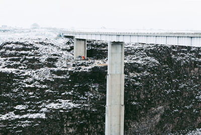 Bridge over sea against sky during winter