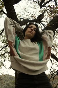 Full length of man standing by tree