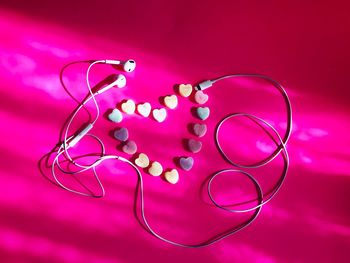 Close-up of heart shape on pink table