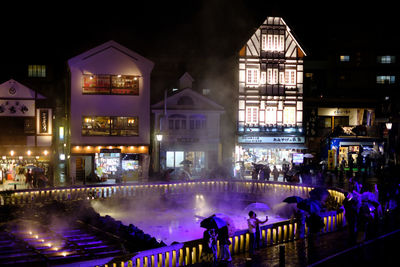 Group of people in illuminated building at night