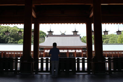 Rear view of man standing outside building