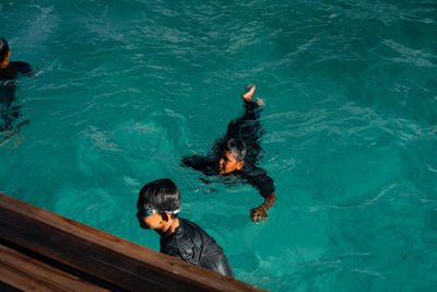 High angle view of boy swimming in pool