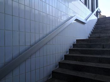 Low angle view of steps by wall at railroad station