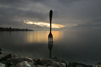 Scenic view of lake against sky during sunset