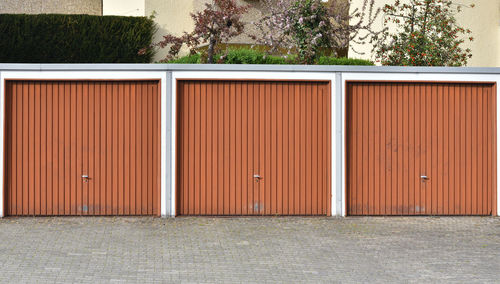 Three brown gates to a garage in a european city