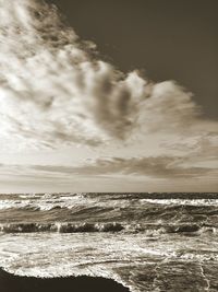 Scenic view of sea against cloudy sky