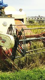 Close-up of bicycle on field against sky