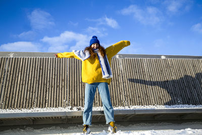 Full length of woman standing against sky