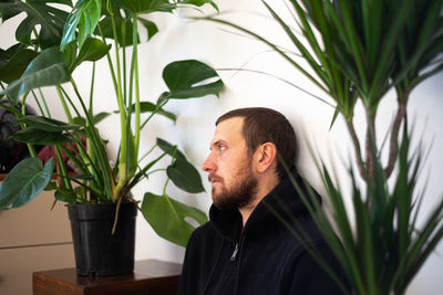 Portrait of young man in potted plant