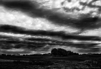 Scenic view of dramatic sky over field