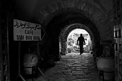 Rear view of man walking in corridor