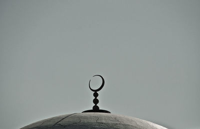 Low angle view of electric lamp against sky