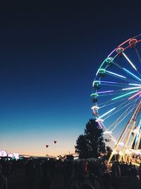 Low angle view of illuminated ferris wheel at night